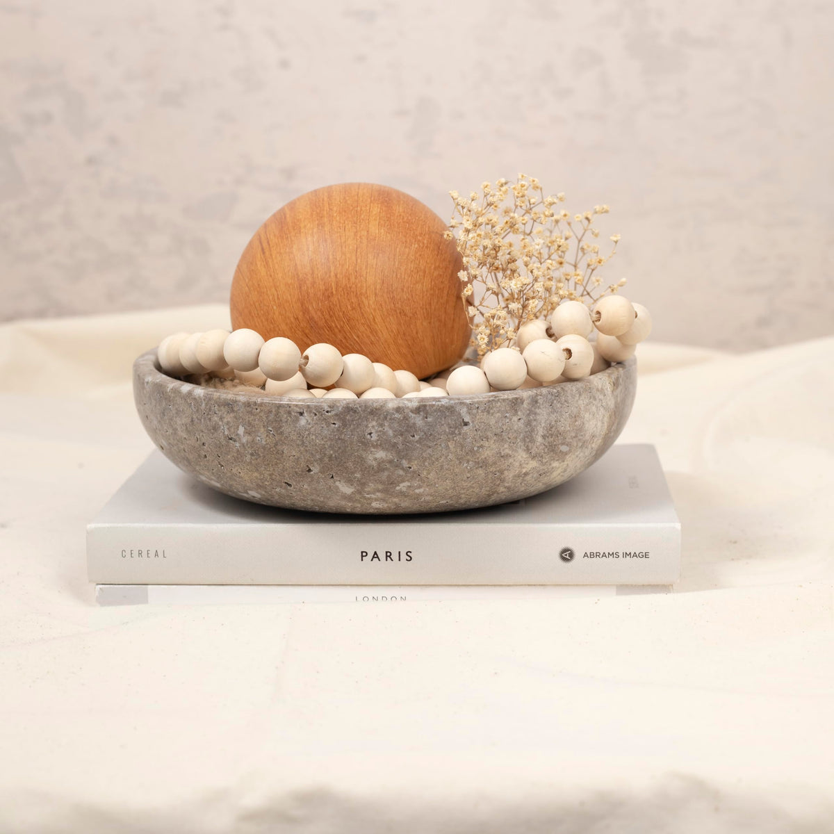 Shelf & Nook travertine bowl on a living room table as decor