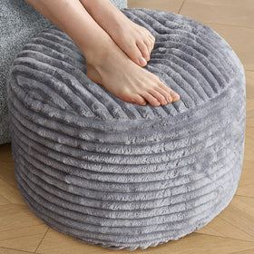 SHOUREN corduroy round ottoman in dark grey used as a footrest with storage