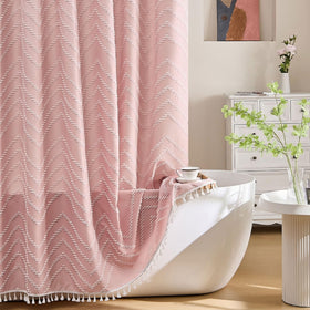 Siiluminisoy pink shower curtain with tassels brightens the bathroom.