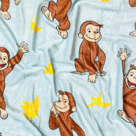 Close-up of plush 185 GSM fleece fabric from Silver Buffalo Curious George throw.