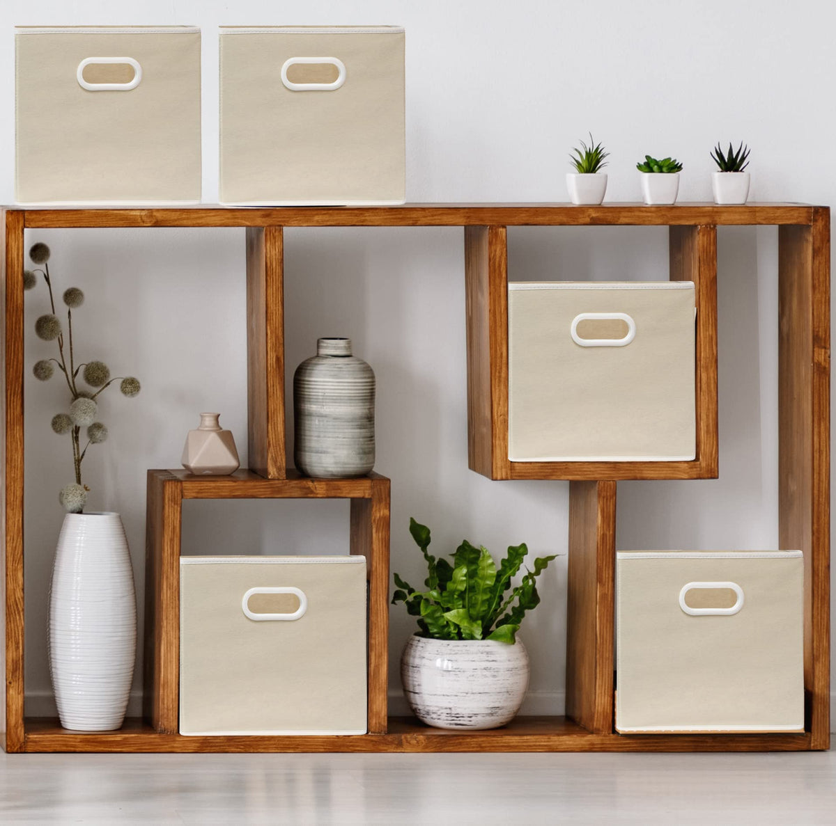 Beige fabric cube bin unfolded shows sturdy 11 inch size for shelves.