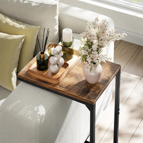Simple Trending C-shaped end table in living room setup beside sofa and lamp