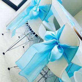 Elegant wedding decor with SINSSOWL sash enhancing seating and aisle.