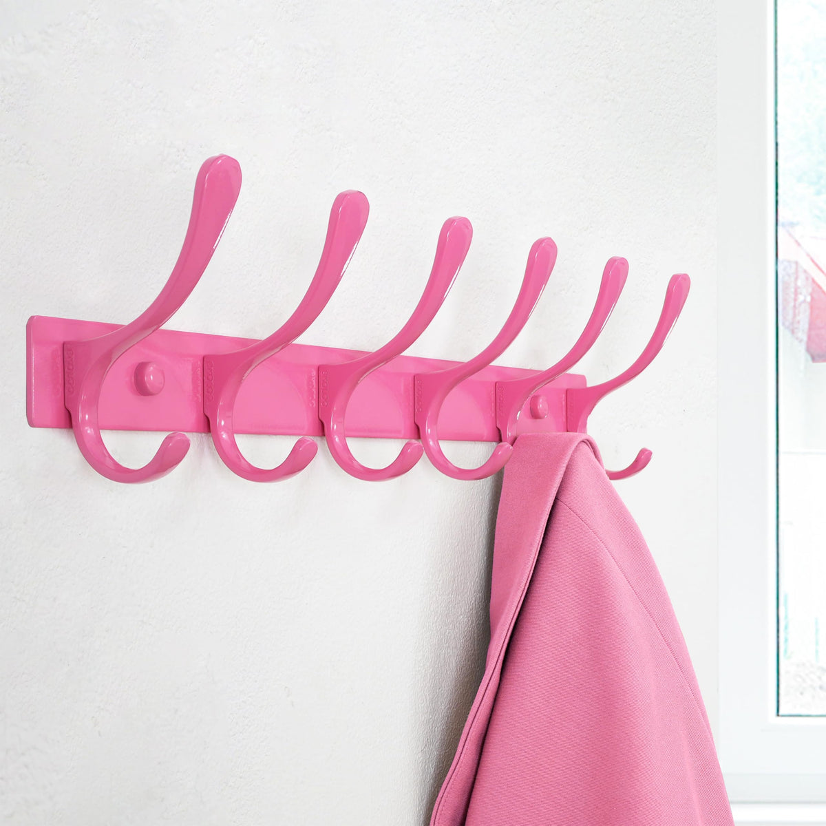 SKOLOO coat rack closeup showcases stainless steel construction and matte pink finish.