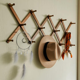SKOLOO long pegs spaced to hold hats, bags, and coats neatly.