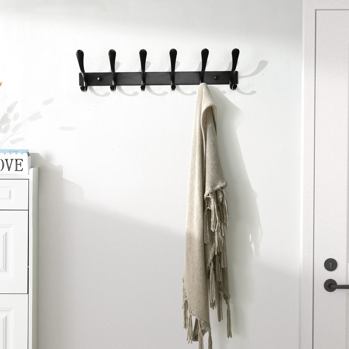 SKOLOO coat rack in entryway demonstrates space-saving organization for daily items.