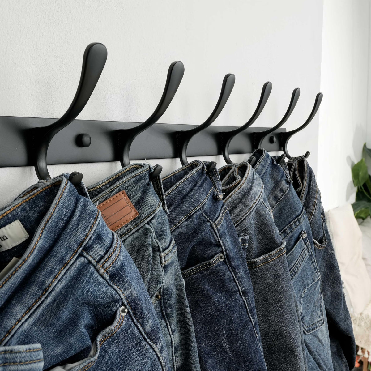 SKOLOO coat rack shows wider spacing and curved ends protecting belongings.