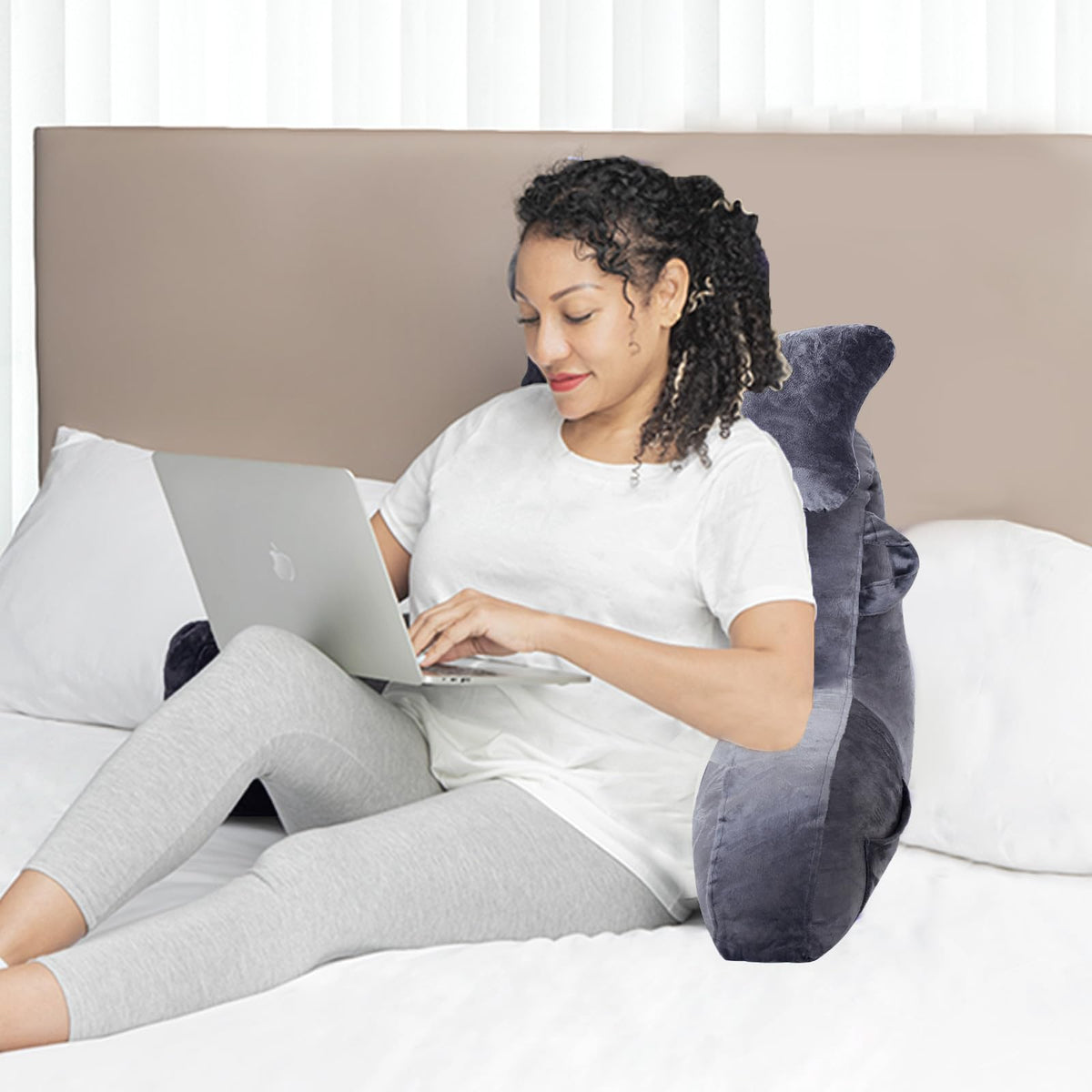 SLIGUY reading pillow supports lounging in bed or on sofa.