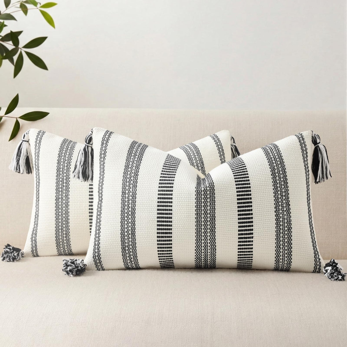 Smile Bee boho outdoor pillow cover in black and cream stripe on a sofa for refreshed decor.
