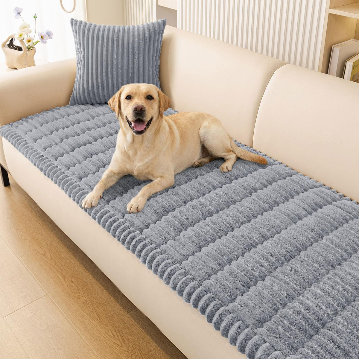 Smiry couch cover on a grey three-cushion sofa protects furniture from pet scratches.