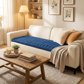 Smiry couch cover on navy sofa demonstrates secure fit for active pets.