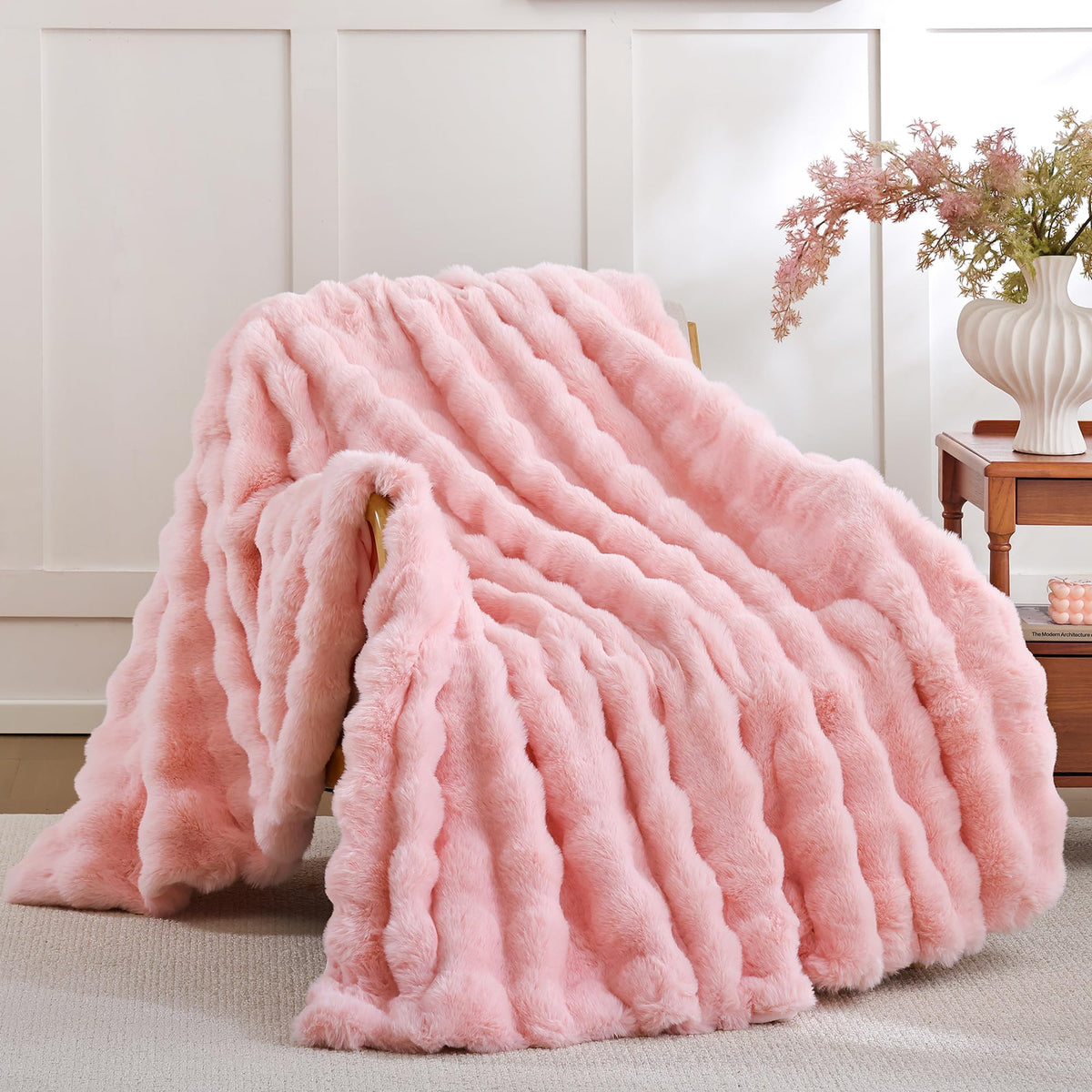 Smoofy blush pink bubble-texture faux fur throw blanket on a couch adds cozy style.