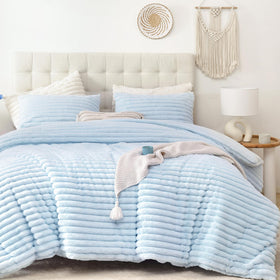 Smoofy fluffy full-size comforter on a bed in light blue for all-season warmth