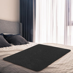 SmoothNovelty mat folded, highlighting its protective barrier for the bed