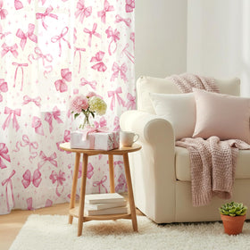 SmoothNovelty pink bow curtains close-up shows playful pattern for cute living room styling.