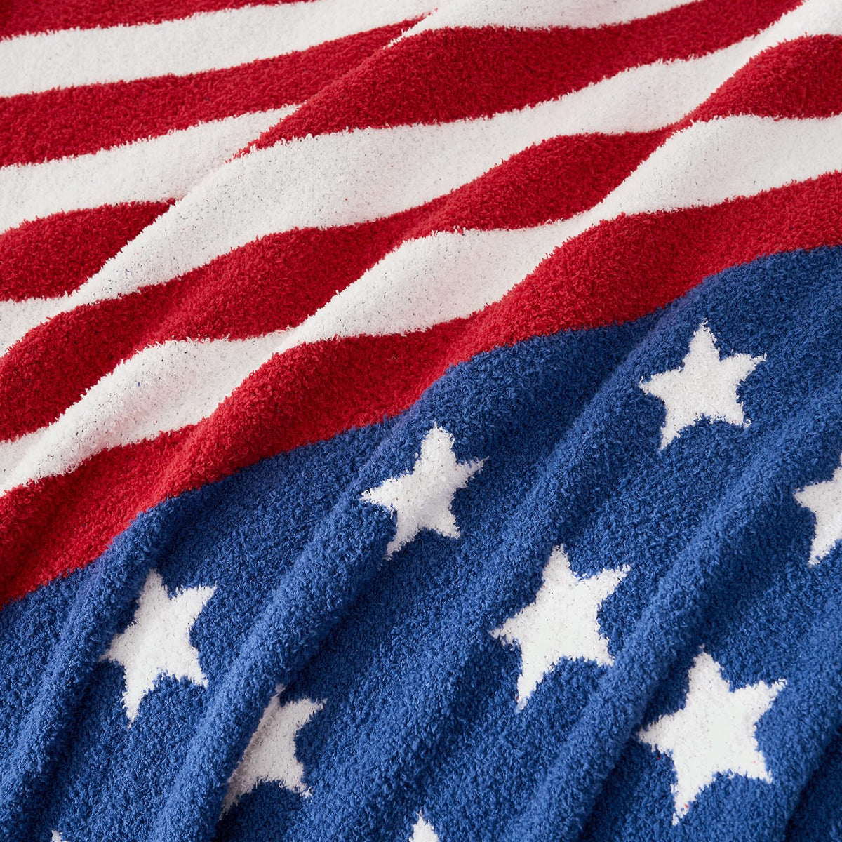 Snuggle Sac American Star Patriotic Throw folded on bed illustrating versatile decor and warmth