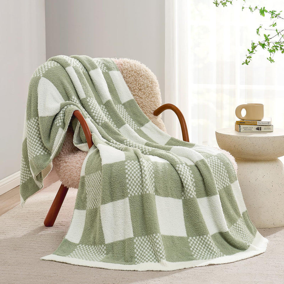 Snuggle Sac checkered blanket in sage green on sofa adds cozy texture.