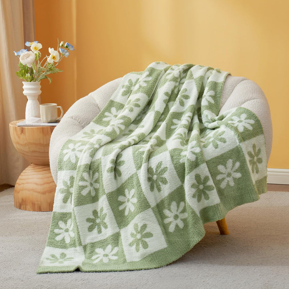 Snuggle Sac checkered flower blanket in sage green for cozy couch styling.