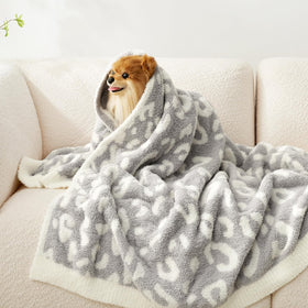 Snuggle Sac gift-ready leopard blanket arrives in ribbon packaging.
