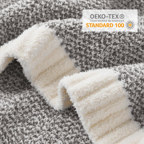 Snuggle Sac grey throw blanket on sofa highlights plush warmth for relaxing evenings.