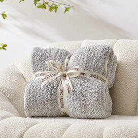 Snuggle Sac Heather Grey Throw draped on couch offers versatile warmth for TV nights.