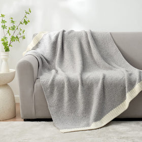 Snuggle Sac Heather Grey Throw spread on bed adds plush comfort for restful mornings.