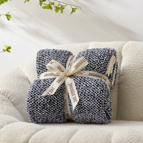 Snuggle Sac throw on sofa enhances living room with soft warmth and style.