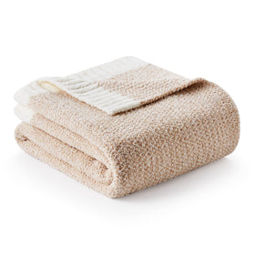 Snuggle Sac Heather Throw Blanket on a sofa, offering plush warmth and ultra-soft feel.
