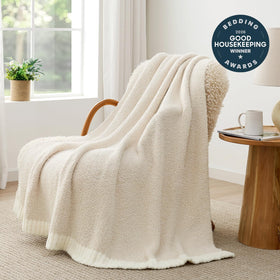 Snuggle Sac Heather Throw Blanket folded on bed adds warmth and style.