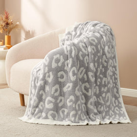 Snuggle Sac leopard blanket close-up highlights ultra-soft knit fabric.