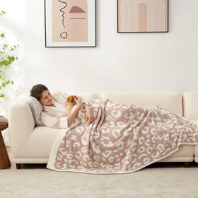 Snuggle Sac leopard blanket on bed adds elegant style and comfort.