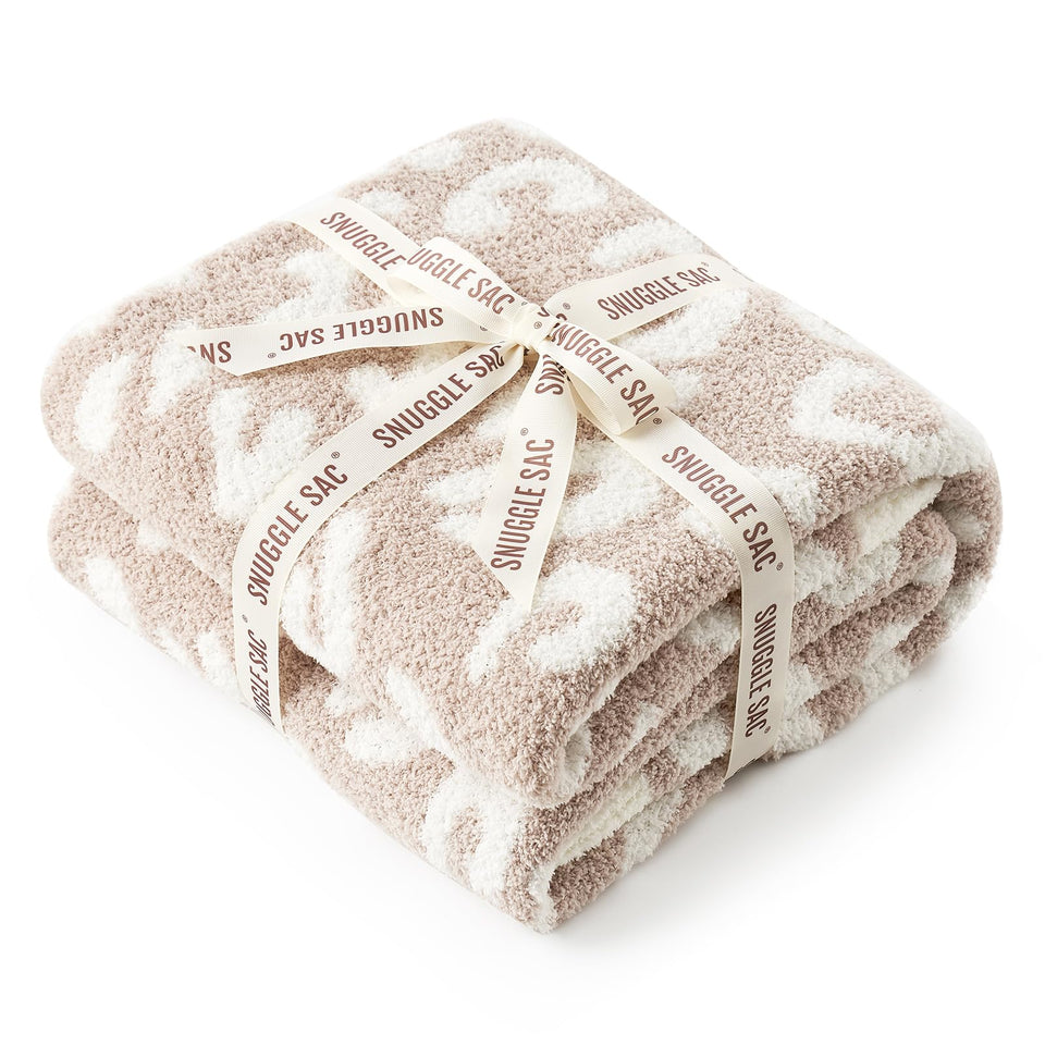 Snuggle Sac leopard throw on sofa delivers cozy warmth for relaxing evenings