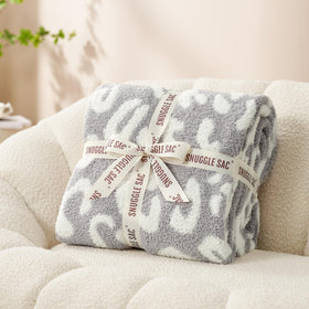 Snuggle Sac machine-washable leopard blanket simplifies home care.