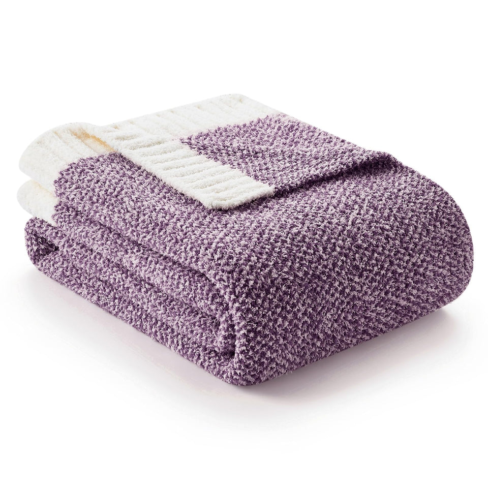 Snuggle Sac purple throw on sofa delivers plush warmth and comfort.