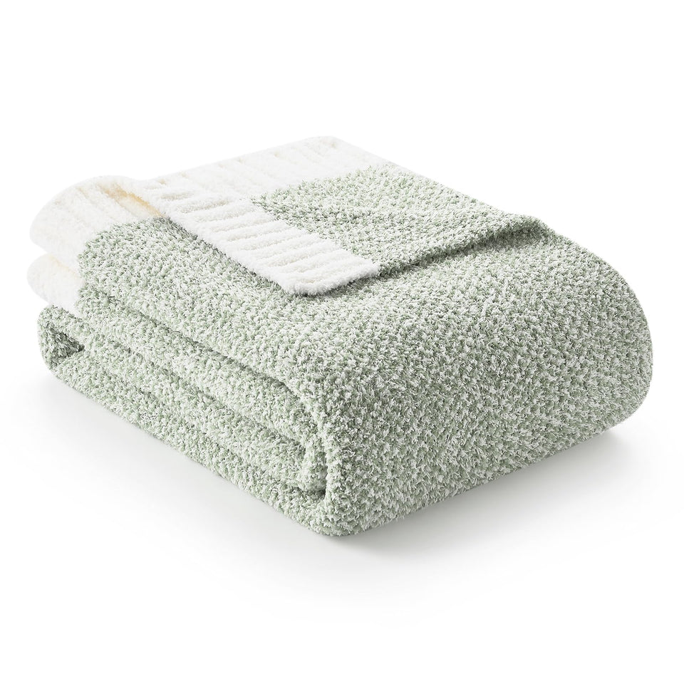 Snuggle Sac sage green throw blanket on couch for cozy evenings.