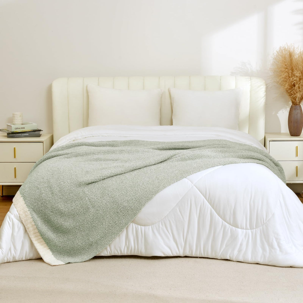 Sage green Snuggle Sac throw across a bed for warmth and decor.
