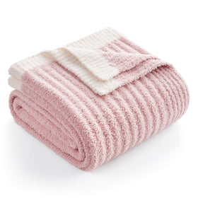 Snuggle Sac spring pink throw blanket on sofa provides cozy warmth for evenings.