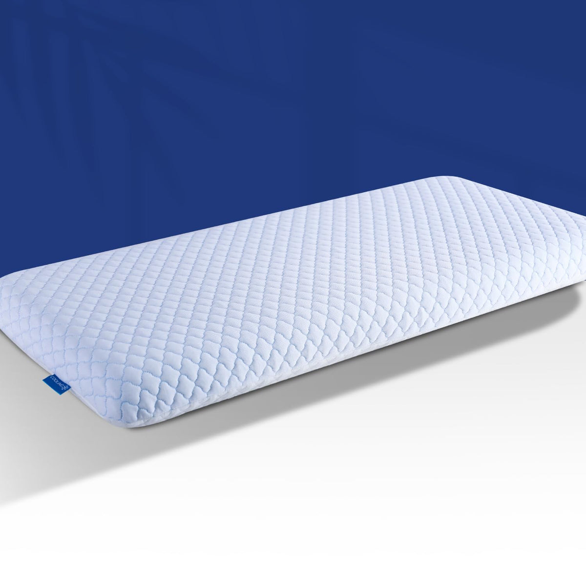 SofGlowly ultra-thin pillow on bed supports stomach sleepers with cooling comfort.