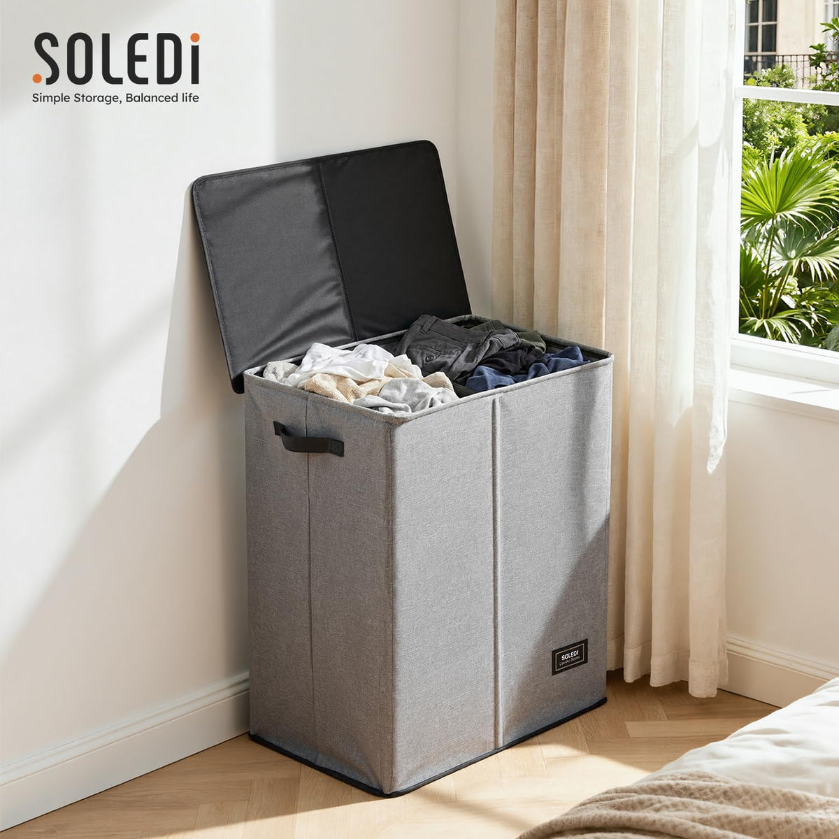 SOLEDI foldable laundry basket collapsed for compact storage under a bed.