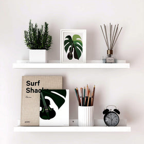 Solrot white floating shelf in living room displaying photos and decor