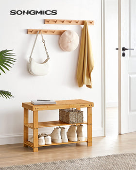 SONGMICS bamboo shelves holding six pairs of shoes on two lower racks.