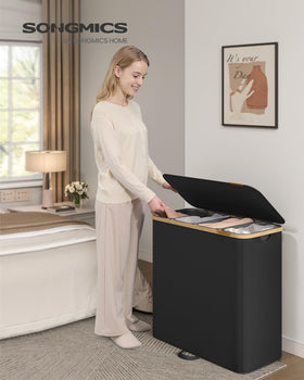 SONGMICS bin with removable liners and foot loop simplifies bag removal and transport.