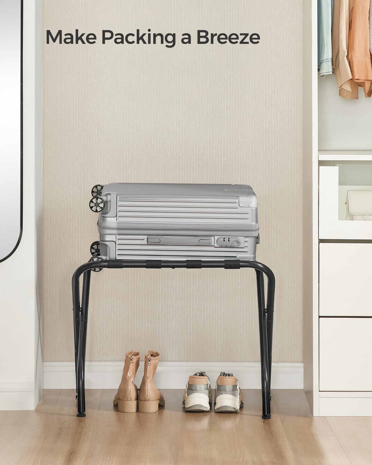 SONGMICS black steel-framed luggage rack in a modern bedroom