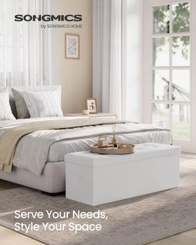 SONGMICS MAZIE ottoman opened to reveal 131 L storage for linens and blankets.