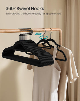 Songmics velvet hangers in ink-black finish for a sleek wardrobe presentation.