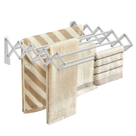 Songmics wall-mounted drying rack in compact setup saves floor space for small laundry areas.