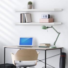 Sorbus living room display on white floating shelves with photos and decor.