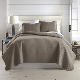 Southshore Fine Living oversized king quilt set draped on a bed for a clean, inviting look.