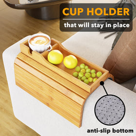SpaceAid bamboo couch cup holder folded for compact storage beside sofa.