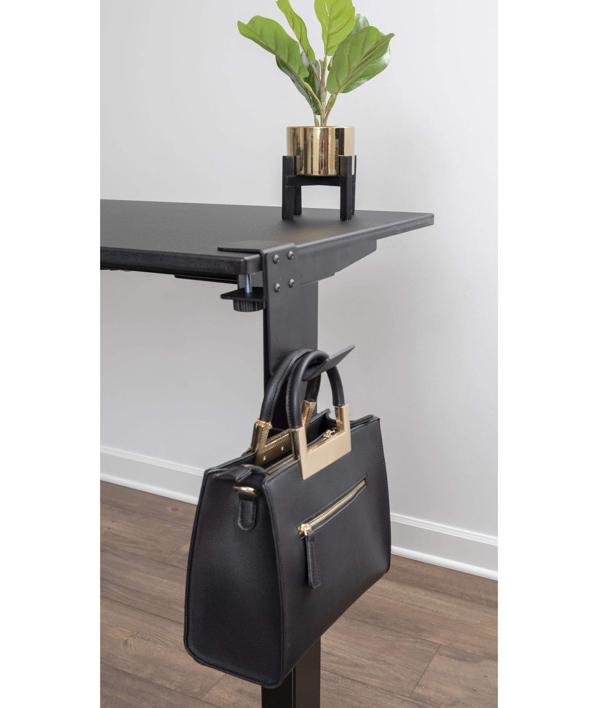 Stand Up Desk Store reversible hook hangs beneath desk or from front for flexible placement.